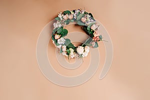 Wreath of flowers on a beige paper background