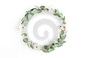 Wreath frame made of branches eucalyptus, leaves and cotton isolated on white background. flat lay, top view