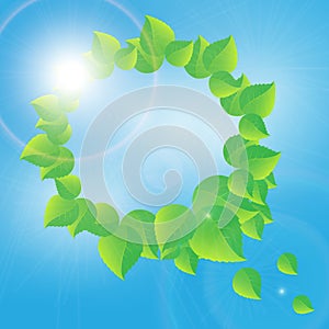 Wreath of green leaves on a sunny sky background