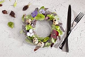 Wreath made of salad leaves, flowers and eggs from above