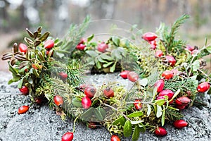 Wreath of rose hips and twigs ate on stone