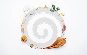 Wreath of twigs and dried leaves on a white background