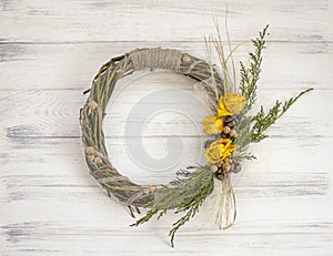 Wreath from a vine with roses. Handmade decor. Wreath of real twigs