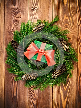 Wreath on the wooden board. Wrapped gift box. Christmas and New year concept