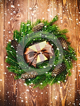 Wreath on the wooden board. Wrapped gift box. Christmas and New year concept