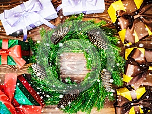 Wreath on the wooden board. Wrapped gift boxes. Christmas and New year concept