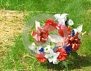 Wreath wtih Red, White and Blue flowers in military cemetery