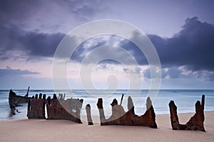 Wreck on australian beach at dawn