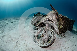 Wreck motorcycle in crystal clear blue water at Racha Yai island