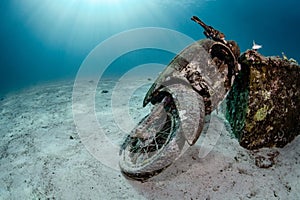 Wreck motorcycle in crystal clear blue water at Racha Yai island