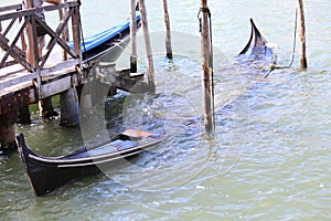wreck of an old gondola sunk in Venice