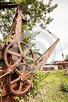 Wreck and rusty mining excavator in old abandoned tin mine