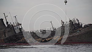 The wreck of tanker Delfi on Odessa beach. Ecological disaster, oil spill on city beaches as. Submerged oil tanker Delfi