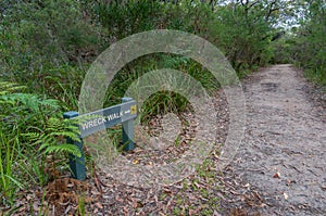 Wreck walk direcion sign and hiking trail, path among the forest