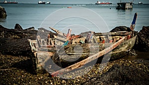 The wreckage of a local fishing boat is stuck in the rocks on the coast of the Gulf