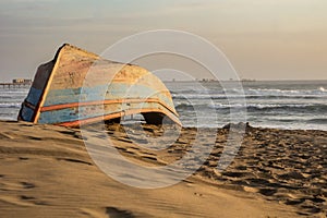 Wreckage of an old boat on the beach by the sea