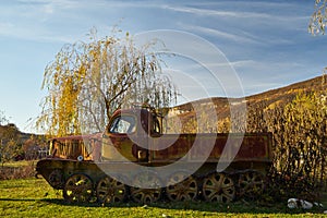 The wreckage of an old tracked all-terrain vehicle.