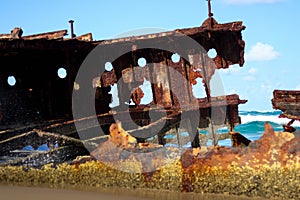 wreckage of a rusted sunken ship stranded on the sand of Australia photo