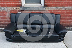 Wrecked Couch on a New York Sidewalk left for Garbage