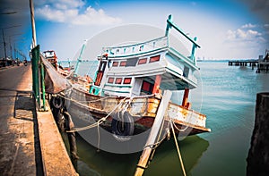 A wrecked fishing boat moored at Bang Saray Pier, Sattahip District