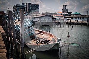 A wrecked fishing boat moored at Bang Saray Pier, Sattahip District