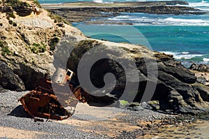 Wrecked old and ruined pusher boat on the beach photo