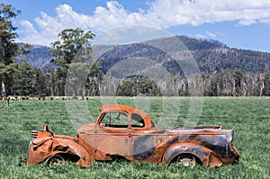 Wrecked, rusted car in an Australian field near Marysville