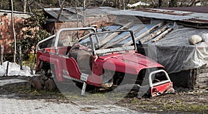 Wrecked vehicle, wrecked, junk, crashed, broken, totalled red SUV or jeep photo