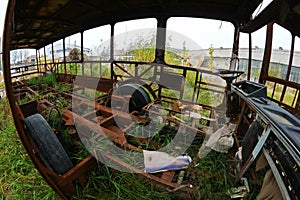 The wrecks of the buses standing on the vehicle cemetery.