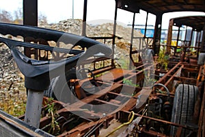 The wrecks of the buses standing on the vehicle cemetery.