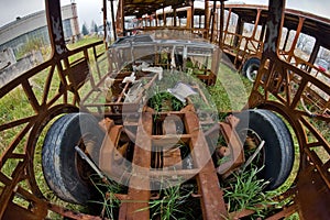 The wrecks of the buses standing on the vehicle cemetery.