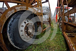 The wrecks of the buses standing on the vehicle cemetery.