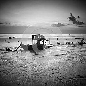 A wrecks old boat at beach. photo