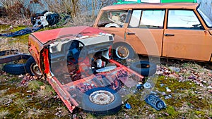 Wrecks of red and orange car