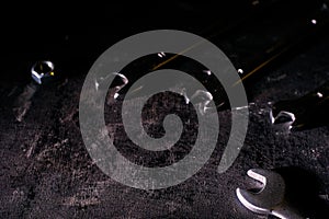 Wrench, bolt, nut isolate on black wood background