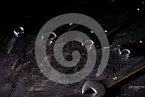 Wrench, bolt, nut isolate on black wood background