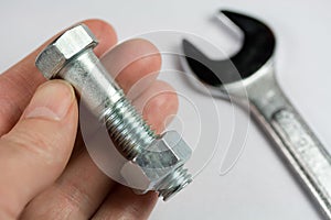 Wrench, Nut and Bolt in Hand