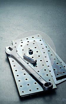 Wrench, nut and on a plate