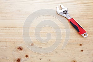 A wrench on a wood table