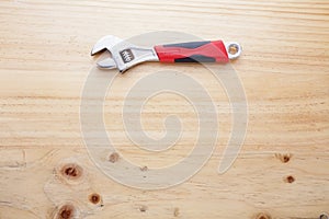 A wrench on a wood table