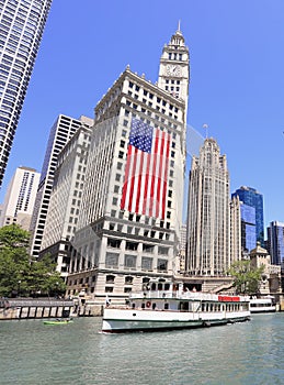 Wrigley Building and Tribune Tower on Michigan Avenue with Illinois flag on the foreground in Chicago
