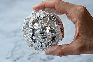 Wrinkled ball of aluminium foil. Recycling concept