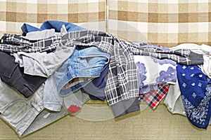 Wrinkled clothes lying on sofa