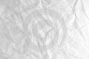 Wrinkled, crumpled white spunbond fabric texture background