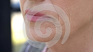 Wrinkled face of elderly woman, cosmetological injections, plastic surgery