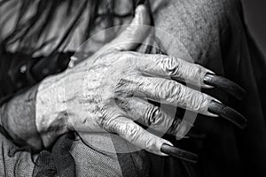 Wrinkled hand with long fingernails