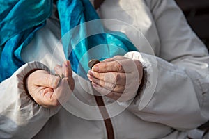 The wrinkled Hands of an old woman sorting through small coins.