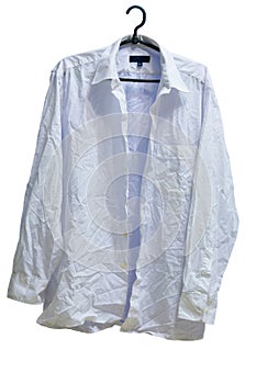 Wrinkled male white laundered shirt on hanger photo