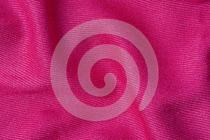 Wrinkled pink fabric texture background close up