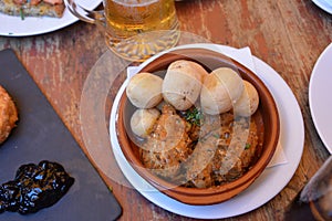 Wrinkled potatoes called papas arrugadas and rabbit, typical food from the Canary Islands, Spain.